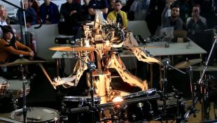 A 4-armed robot with a mohawk playing the drums